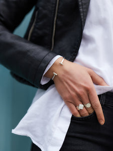 model wearing sustainable handmade rings in eco sterling silver and gold
